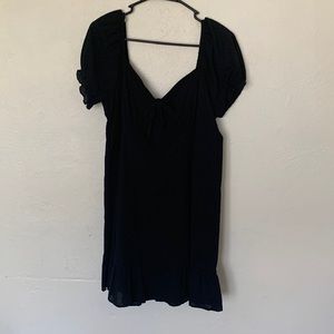 Black, mini dress with puffed shoulders.
